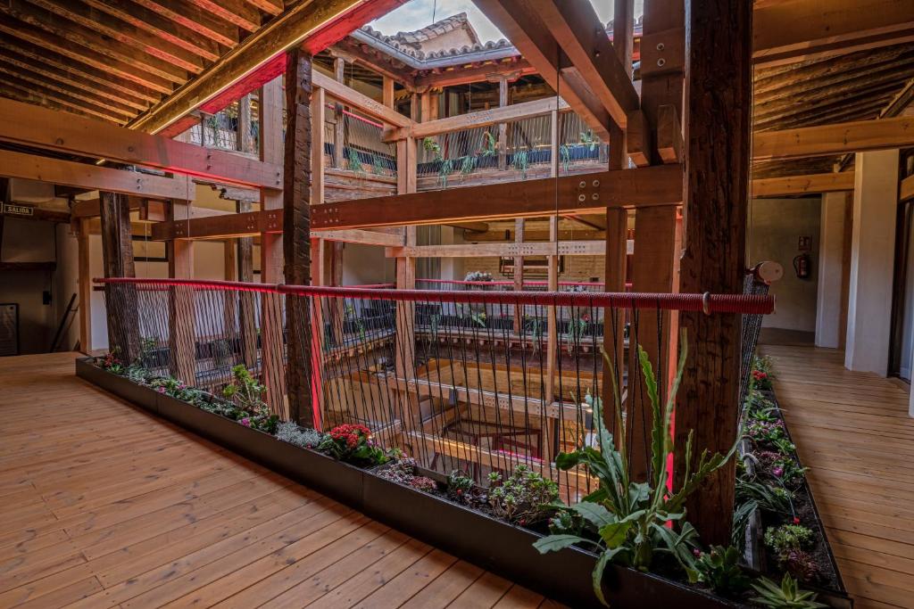 a building with a bird cage on a wooden deck at Casa Palacio Rodrigo de la Fuente by Príncipe David - Seis Apartamentos de Lujo - in Toledo