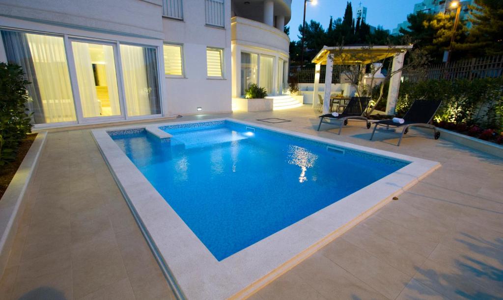 a swimming pool in the backyard of a house at Luxury Apartment Split in Split