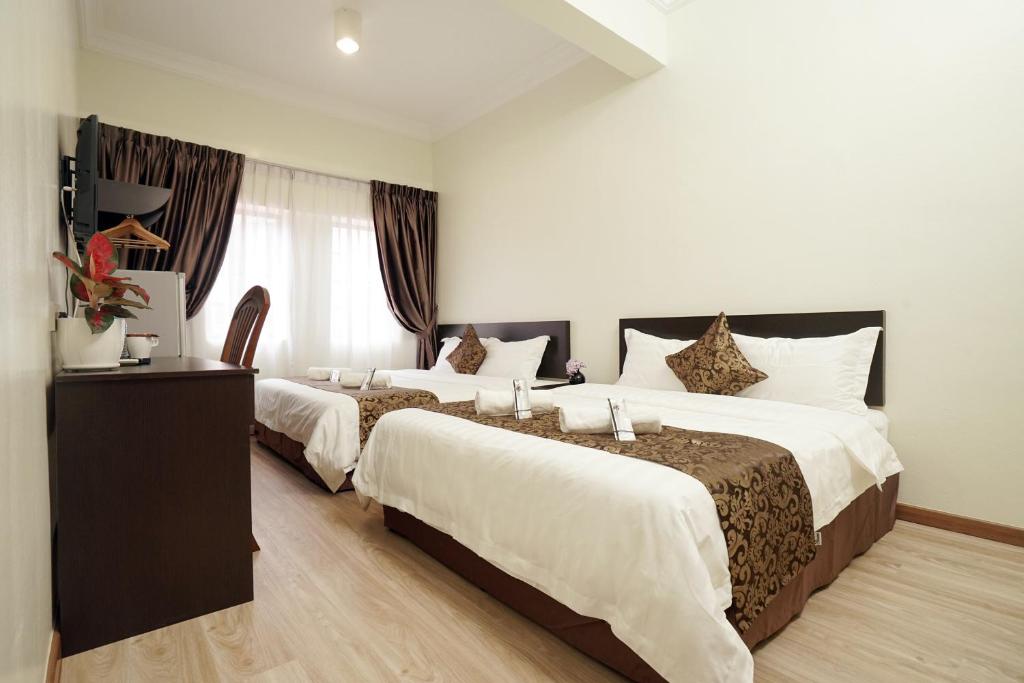Postel nebo postele na pokoji v ubytování RJ Hotel Kulai