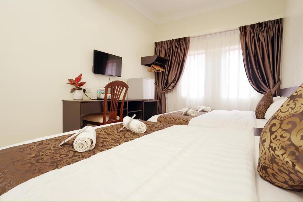 Postel nebo postele na pokoji v ubytování RJ Hotel Kulai
