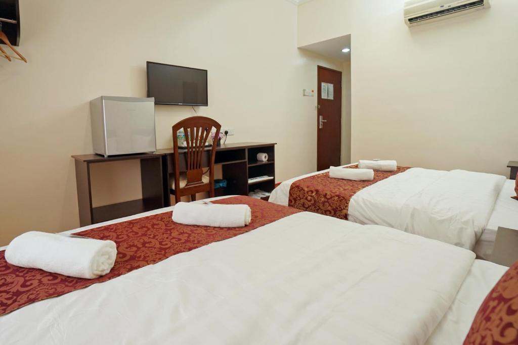 Postel nebo postele na pokoji v ubytování RJ Hotel Kulai