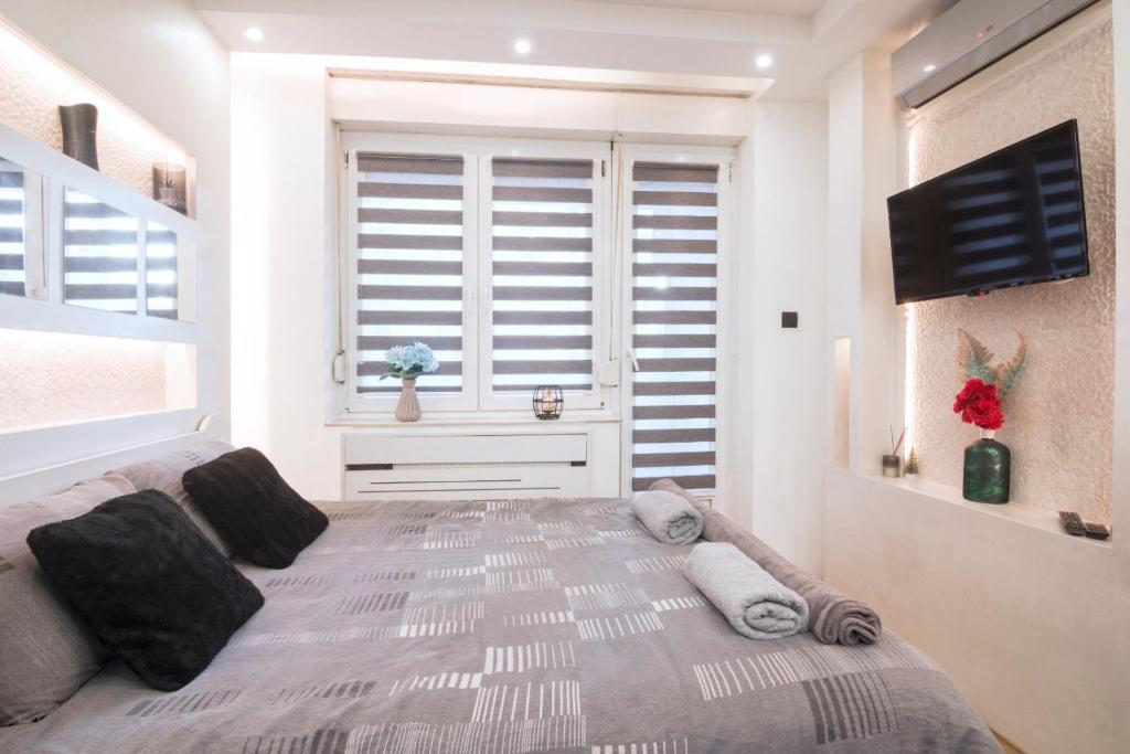 a bedroom with a large bed and a window at Arizona in Novi Sad