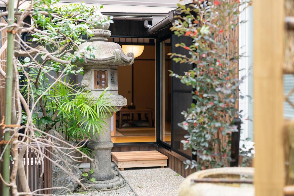 a japanese lantern in front of a door at JPRESERVE Toji in Kyoto