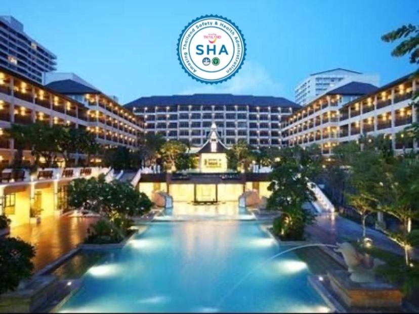 a hotel with a large pool in front of a building at The Heritage Pattaya Beach Resort-SHA in Pattaya South