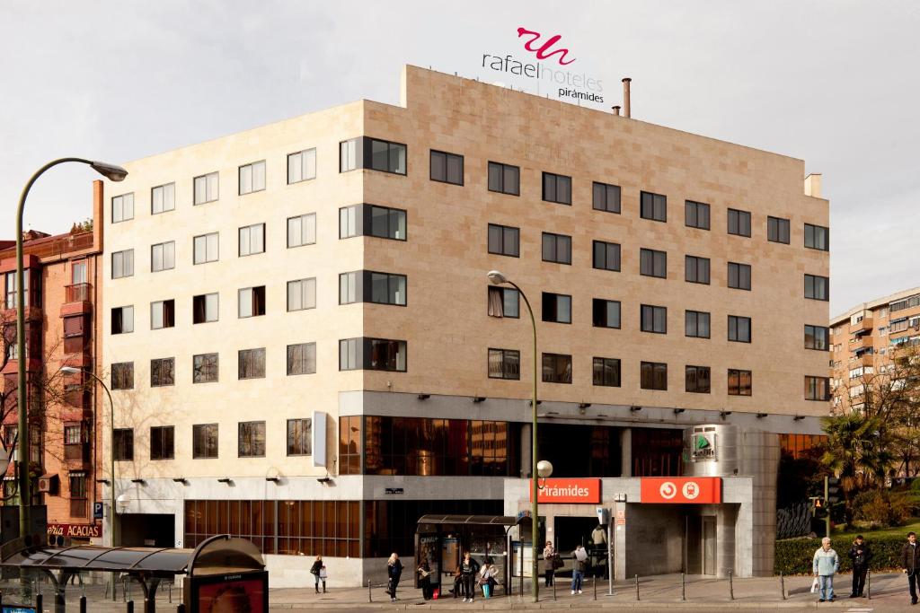 a large building with a sign on the side of it at Rafaelhoteles Piramides in Madrid