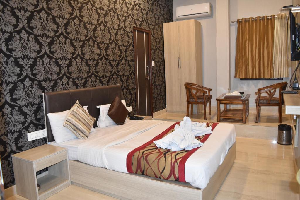 a bedroom with a bed with towels on it at Thakur Boutique Hotel in Udaipur