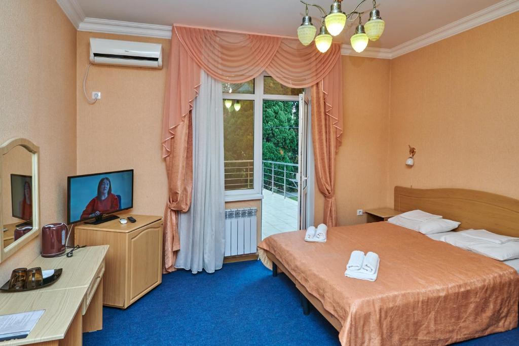 Ένα ή περισσότερα κρεβάτια σε δωμάτιο στο Hotel Sevan
