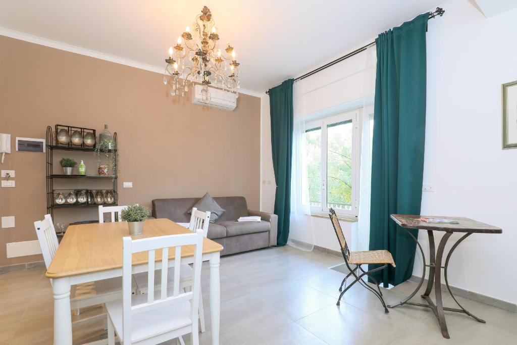 a dining room and living room with a table and chairs at Centro Residenze Domus Sofiae in Genoa