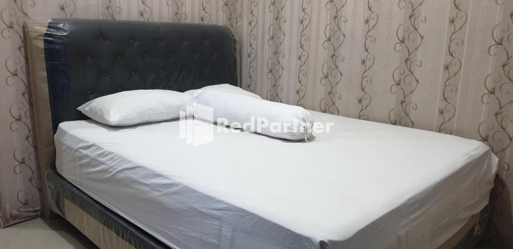 Postel nebo postele na pokoji v ubytování Homestay MM Syariah RedPartner