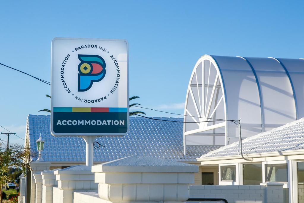 a sign for aacomulation in front of a building at Parador Inn in Adelaide