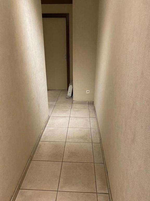 an empty hallway with a cat sitting on the floor at 10mins from Brussels Airport 2 rooms living room and Patio in Zaventem