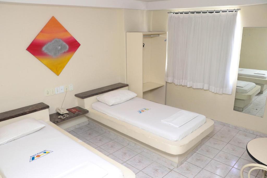 Postel nebo postele na pokoji v ubytování Hotel Piramide Pituba - Av Paulo VI