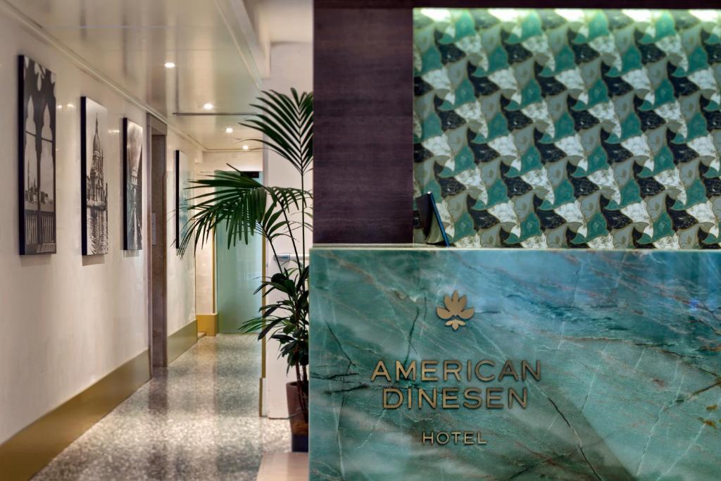 a hallway of an american dinner hall with a hotel sign at Hotel American-Dinesen in Venice