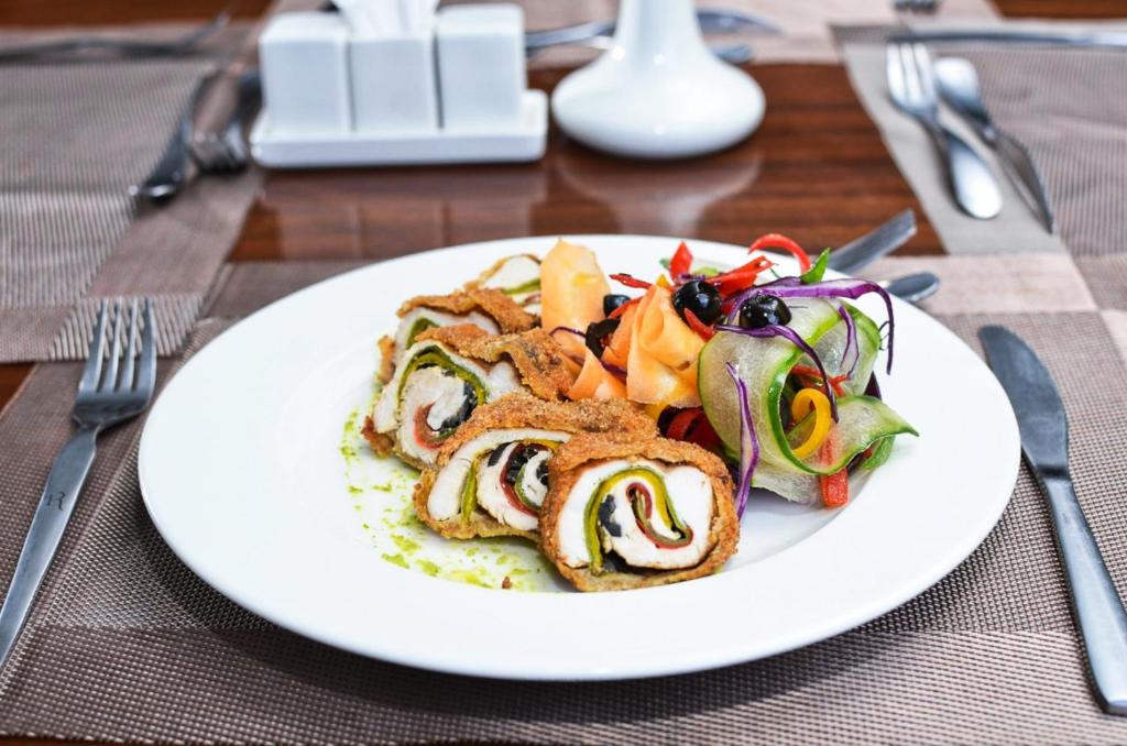 a white plate of food on a table at Hotel Rio in Nairobi