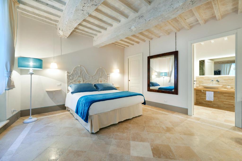 Säng eller sängar i ett rum på Palazzo Pio III - Residenza d'epoca