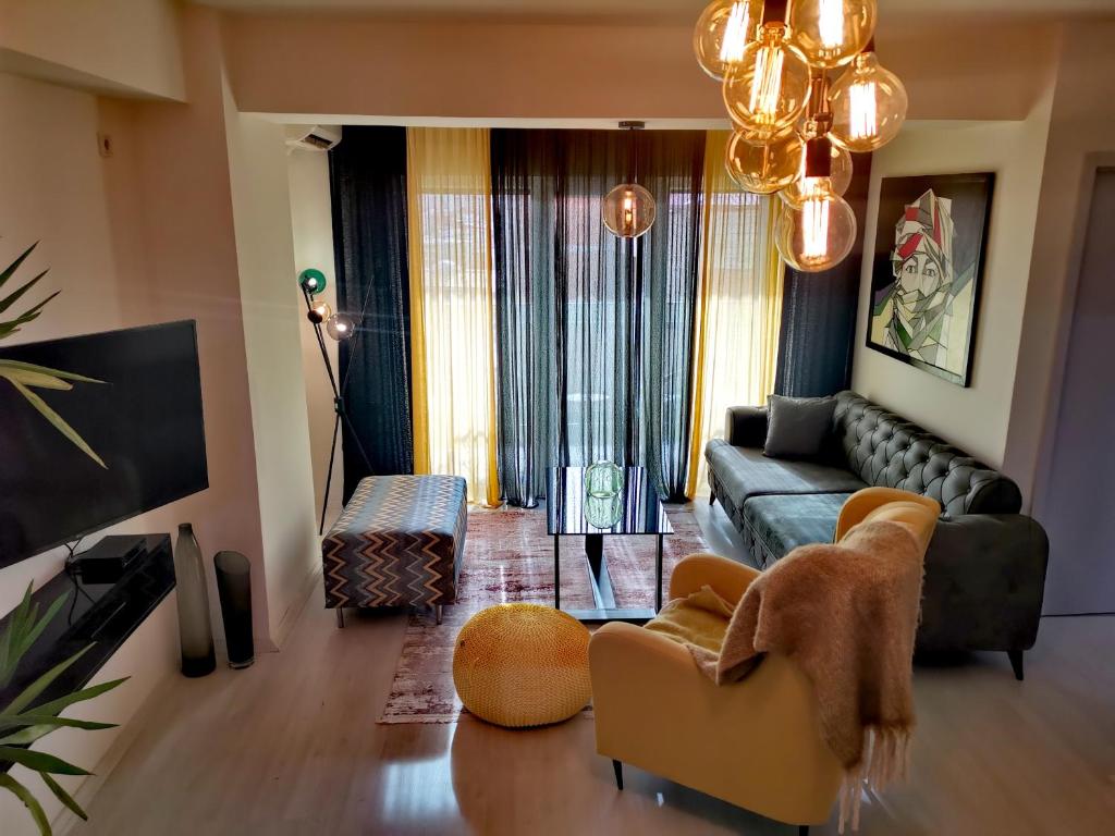 a living room with a couch and a tv at Sandev Apartments in Štip