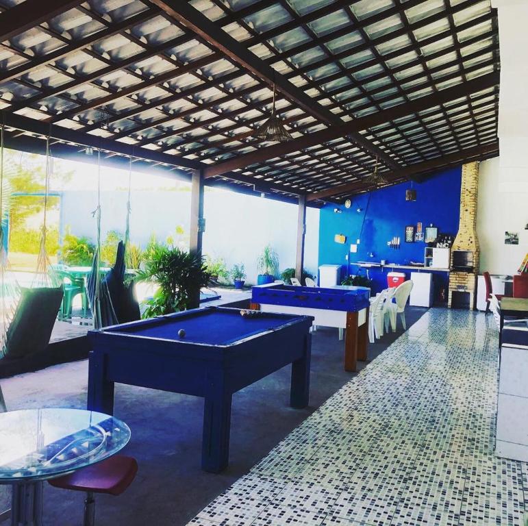 two pool tables in a room with a large window at Casa ampla em Itacimirim - BA - ITACIMAX in Itacimirim