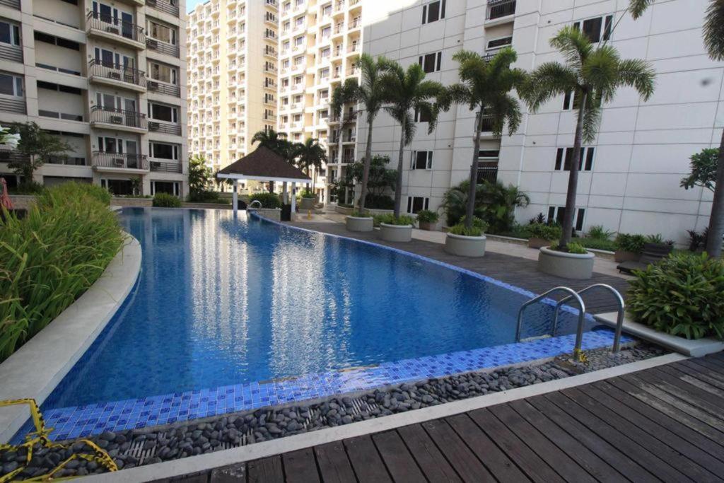 a large swimming pool in the middle of a building at Solemare Parksuites Condo in Manila
