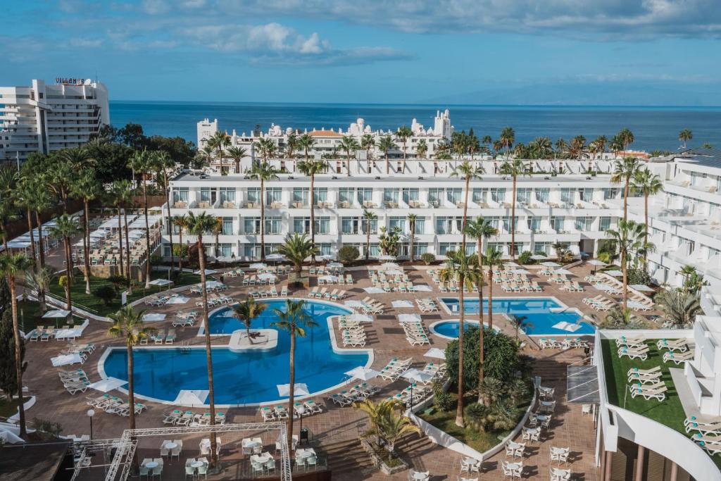 a large swimming pool with a large building behind it at Iberostar Las Dalias - All Inclusive in Adeje