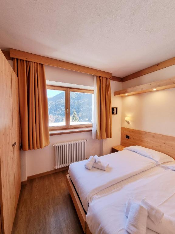 Postel nebo postele na pokoji v ubytování Hotel San Carlo, tra Bormio e Livigno