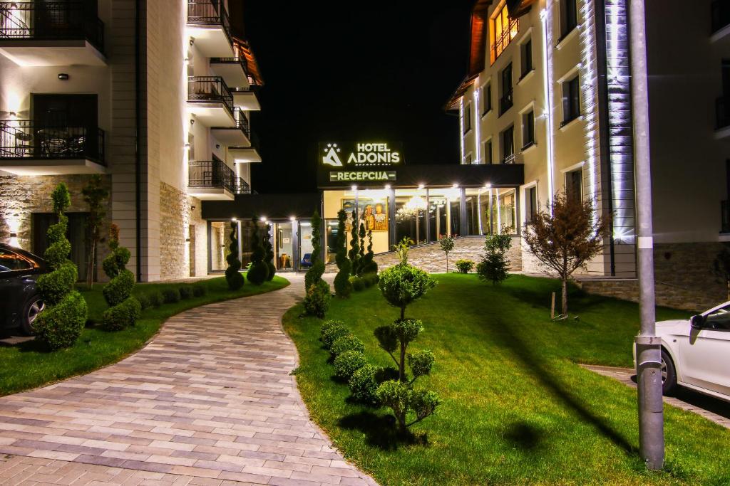 a walkway in front of a building at night at Adonis 2021 in Zlatibor