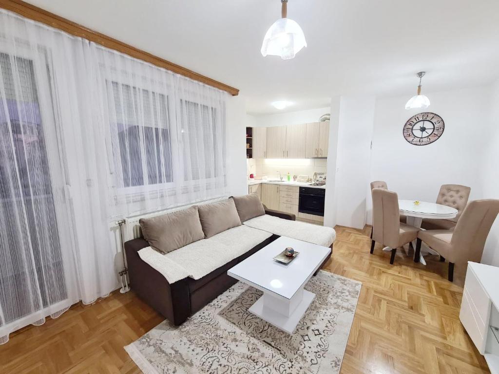 a living room with a couch and a table at Apartman City in Bijeljina
