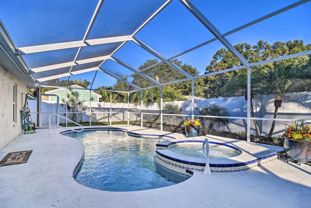 an indoor swimming pool with a large glass ceiling at 4 Mi to Beach Gem with Pool and Lanai in Seminole! in Seminole