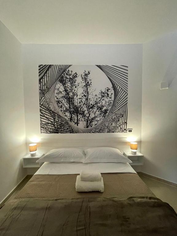 a bedroom with a bed with a painting on the wall at Casa Nicola Maria in Grottaglie