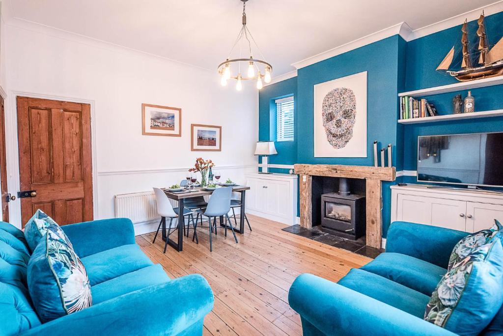 a blue living room with a blue couch and a table at 232a High Street Aldeburgh Air Manage Suffolk in Aldeburgh