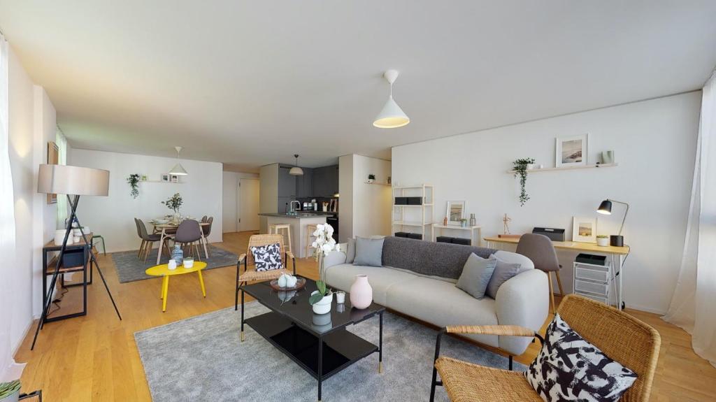 a living room with a couch and a table at Superbe modern apartment in city center in La Chaux-de-Fonds