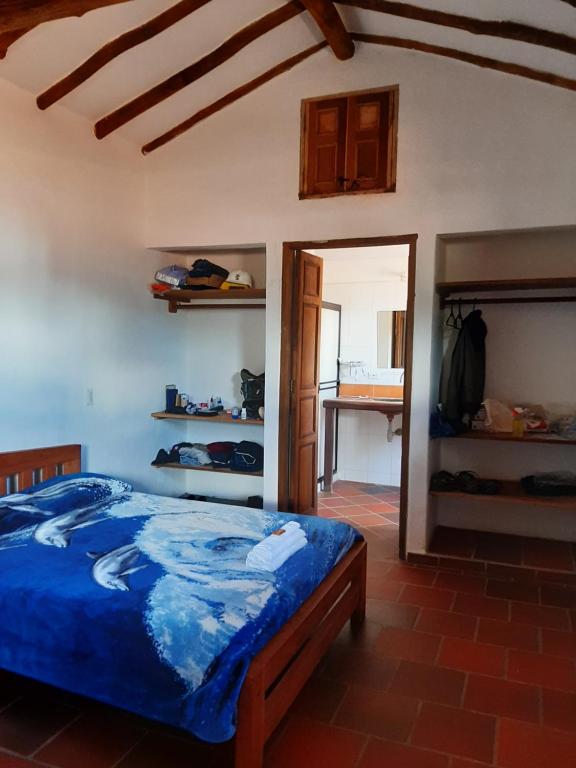 a bedroom with a blue bed in a room at Hotel El santuario in California