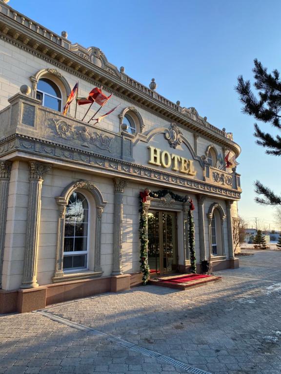a hotel with a sign on the front of it at Hotel Astam in Kostanay