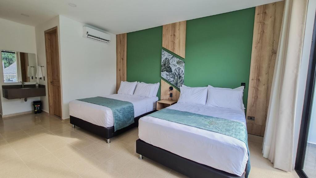 Postel nebo postele na pokoji v ubytování Hotel Arbóreo Doradal