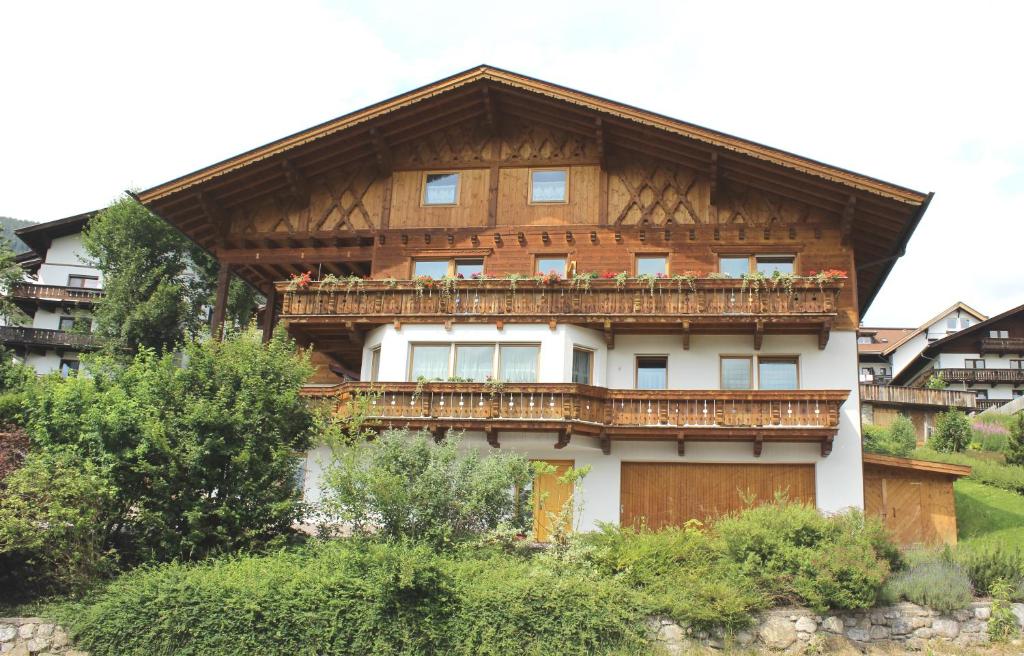 a large wooden building with a balcony on it at Appartementhaus Untere Tanne in Lermoos