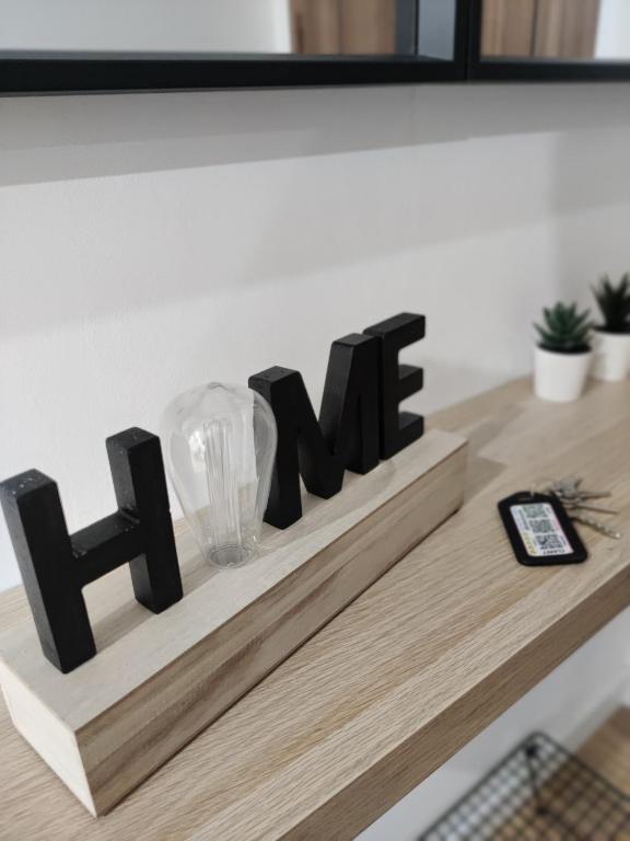 a sign on a counter that reads her at New Apartment Claret in Xàtiva