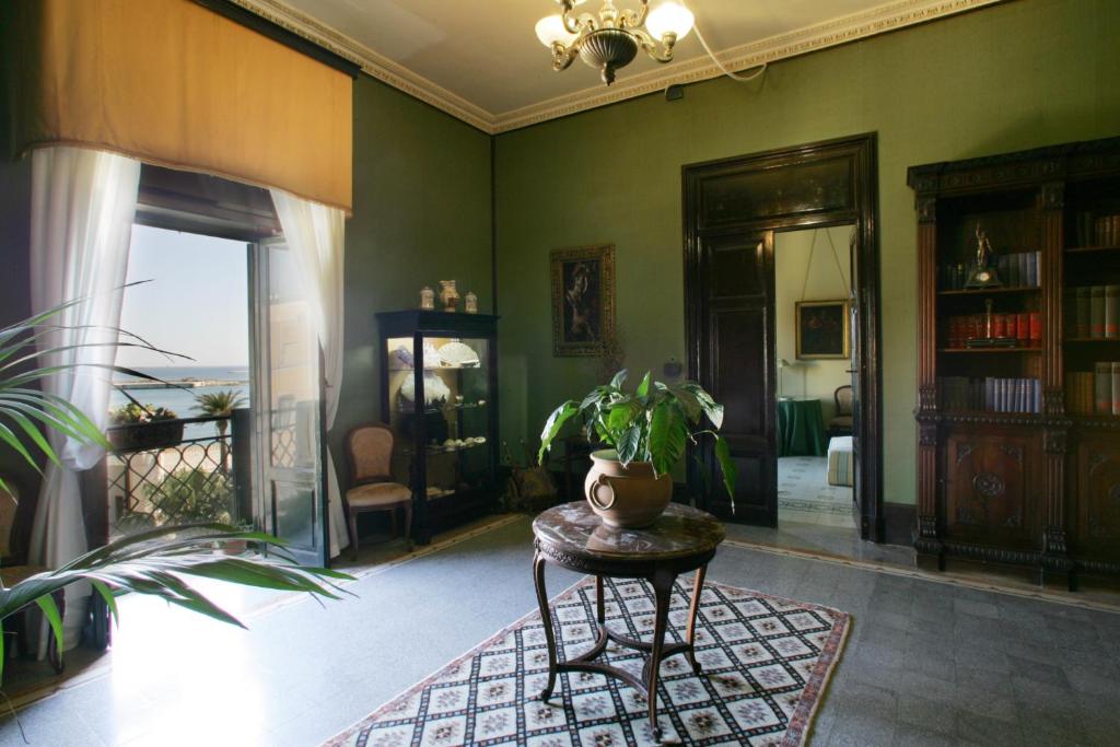 a living room with a table and a plant at Alla Marina Bed And Breakfast in Trapani