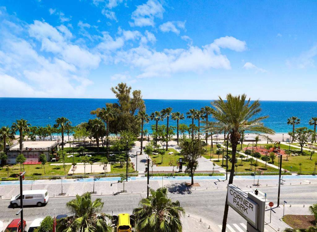 a view of a park with the ocean in the background at The Corner Park Hotel in Antalya