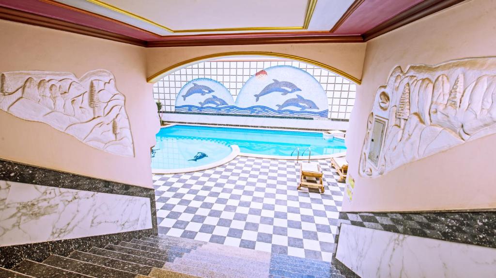 a room with a pool and a tile floor at Rare New Marina Hotspot With Pool & Fast Free WIFI - Western Standards - Sheraton Plaza 415 in Hurghada