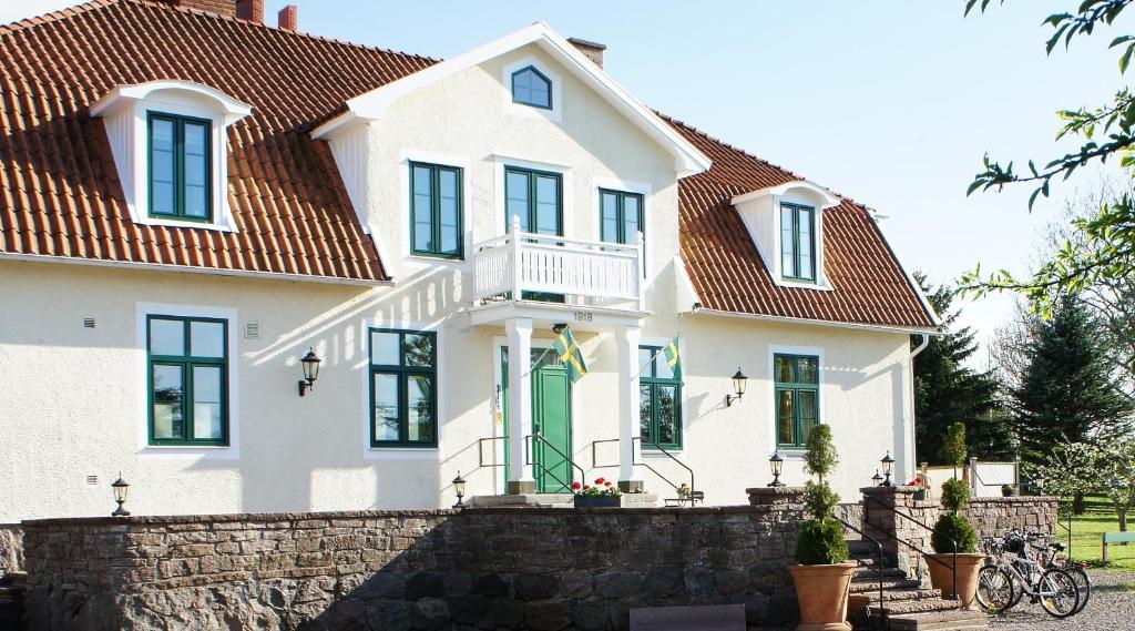 a white house with a red roof at Guntorps Herrgård in Borgholm