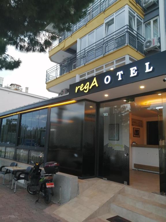 a motorcycle parked in front of a building at REGA OTEL in Antalya