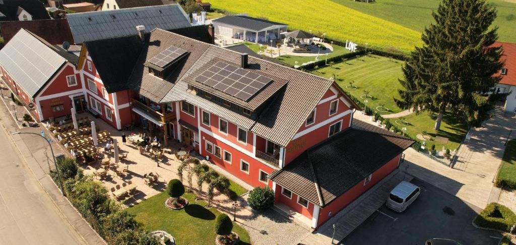 an aerial view of a house with solar panels on it at Landhotel Grabinger in Schwandorf in Bayern