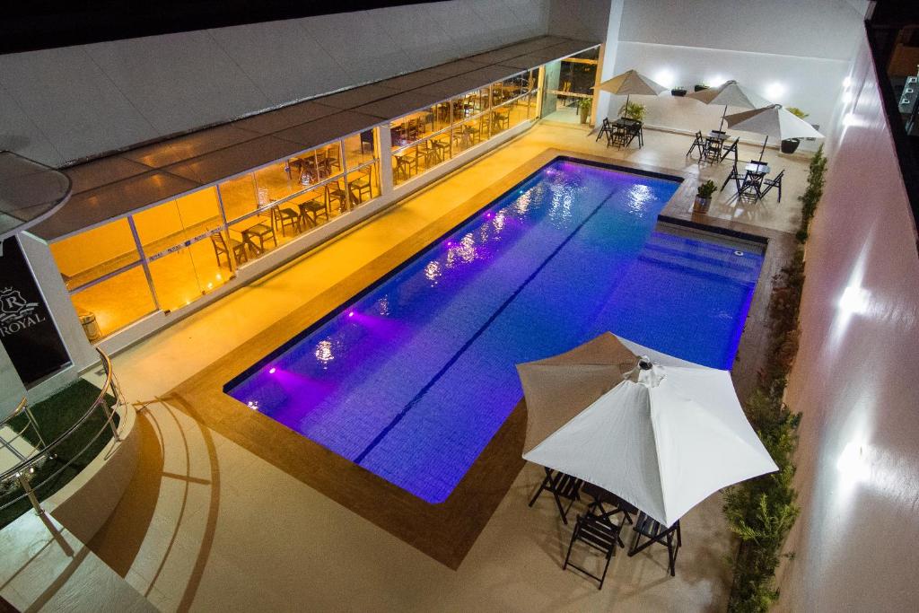 an overhead view of a swimming pool with an umbrella at ROYAL Hotel & Gastronomia in Macapá