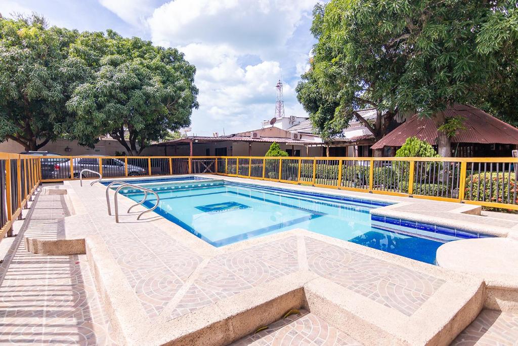 a swimming pool with a fence around it at Hotel Casa Finca La Maracuya in Ríohacha