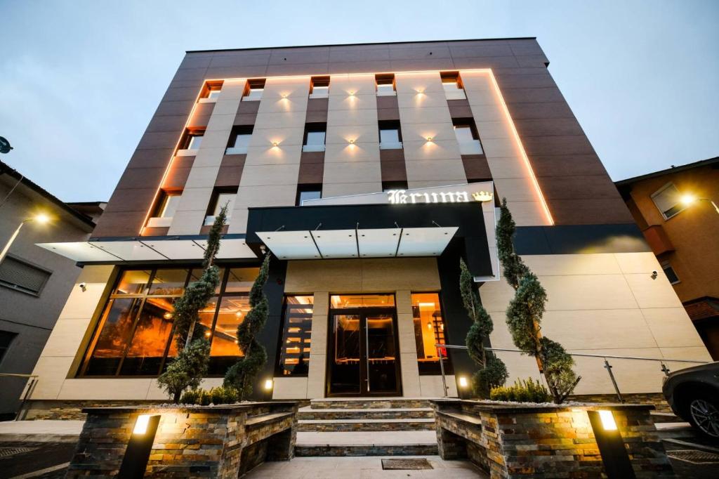 a hotel front of a building at night at Zlatna Kruna in Banja Luka