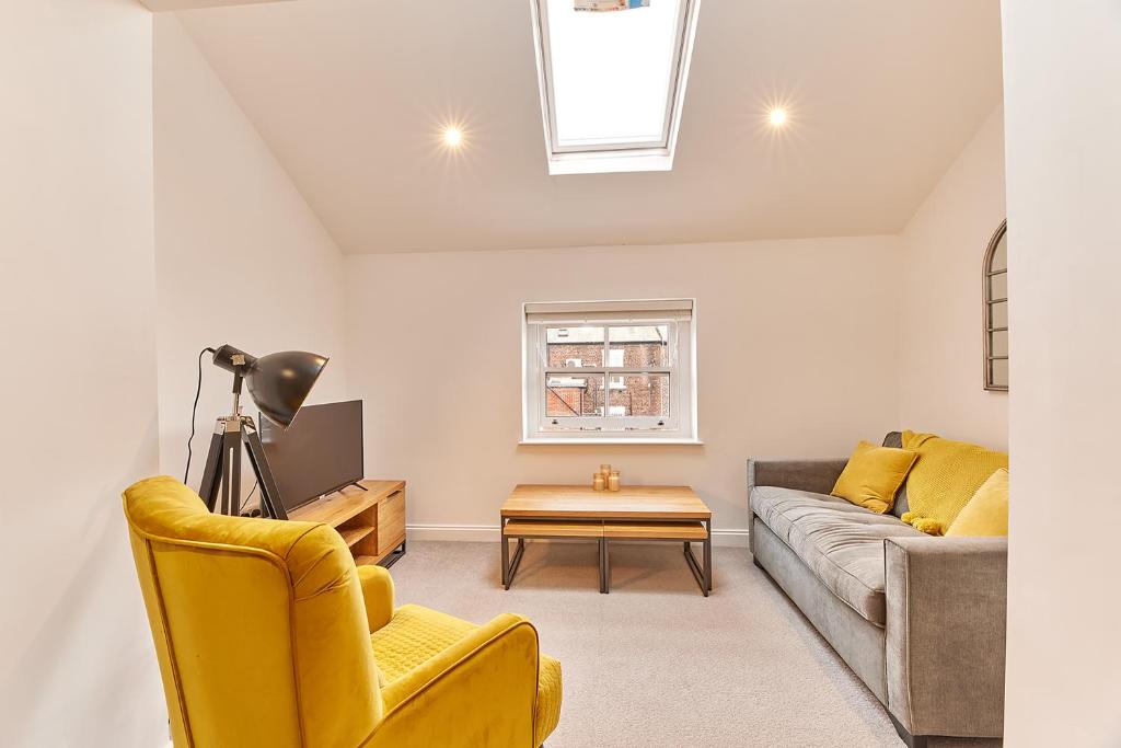 a living room with a couch and a table at Barnes boutique apartment in Sunderland