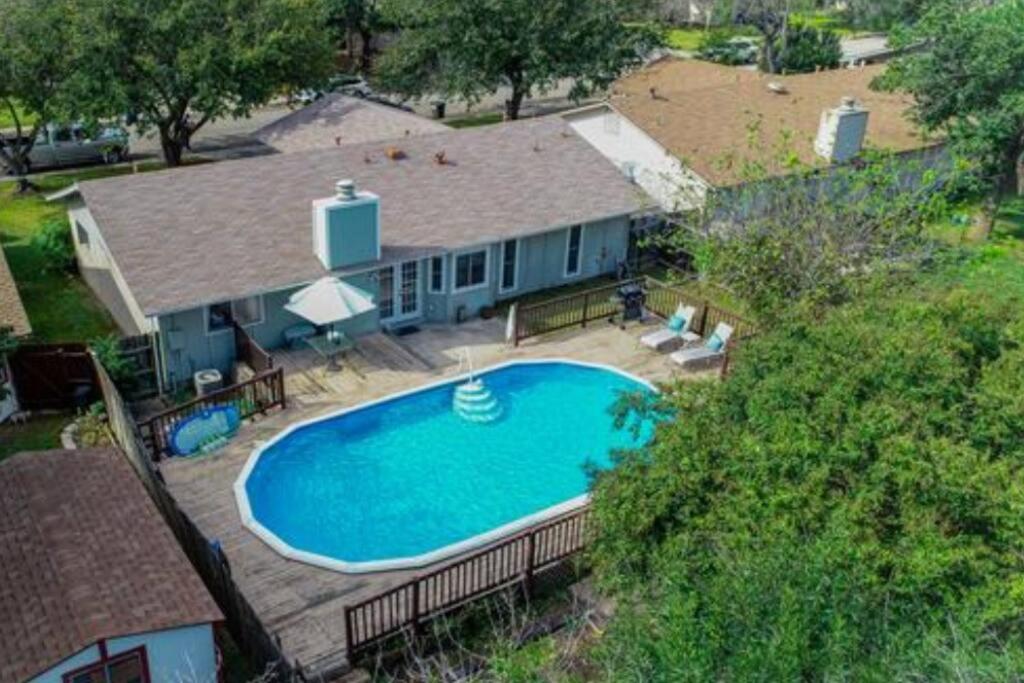 an overhead view of a swimming pool in front of a house at Cheerful 3-bedroom with a pool in San Antonio