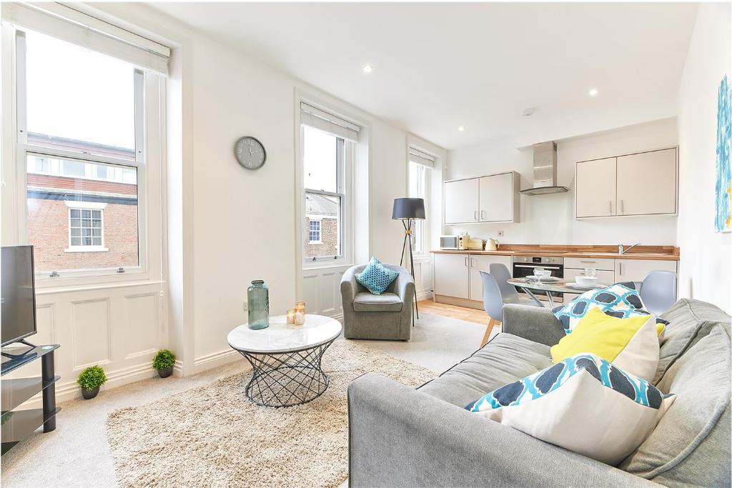 a living room with a couch and a table at Herrington boutique apartment in Sunderland