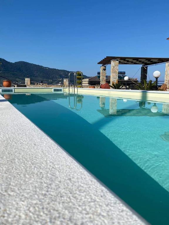 a large swimming pool with blue water at Annas Villa in Skala Potamias
