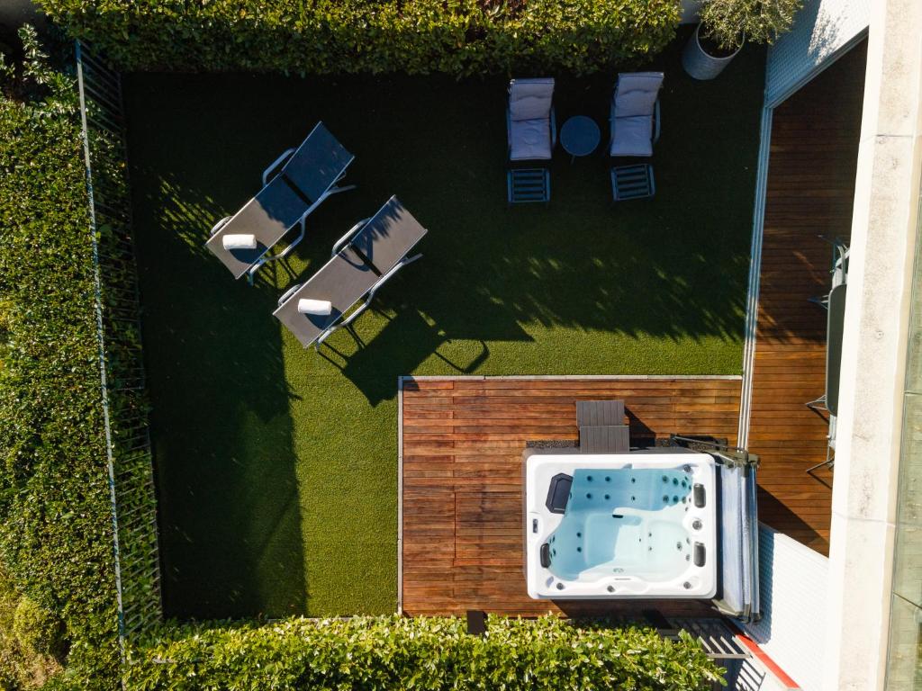 an overhead view of a backyard with a pool and chairs at Apartments Feral Portorož in Portorož