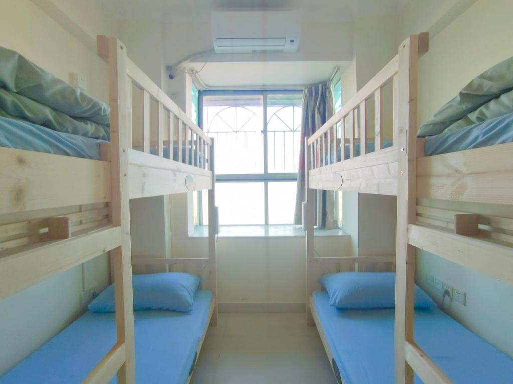 Postel nebo postele na pokoji v ubytování 都市小憩青旅